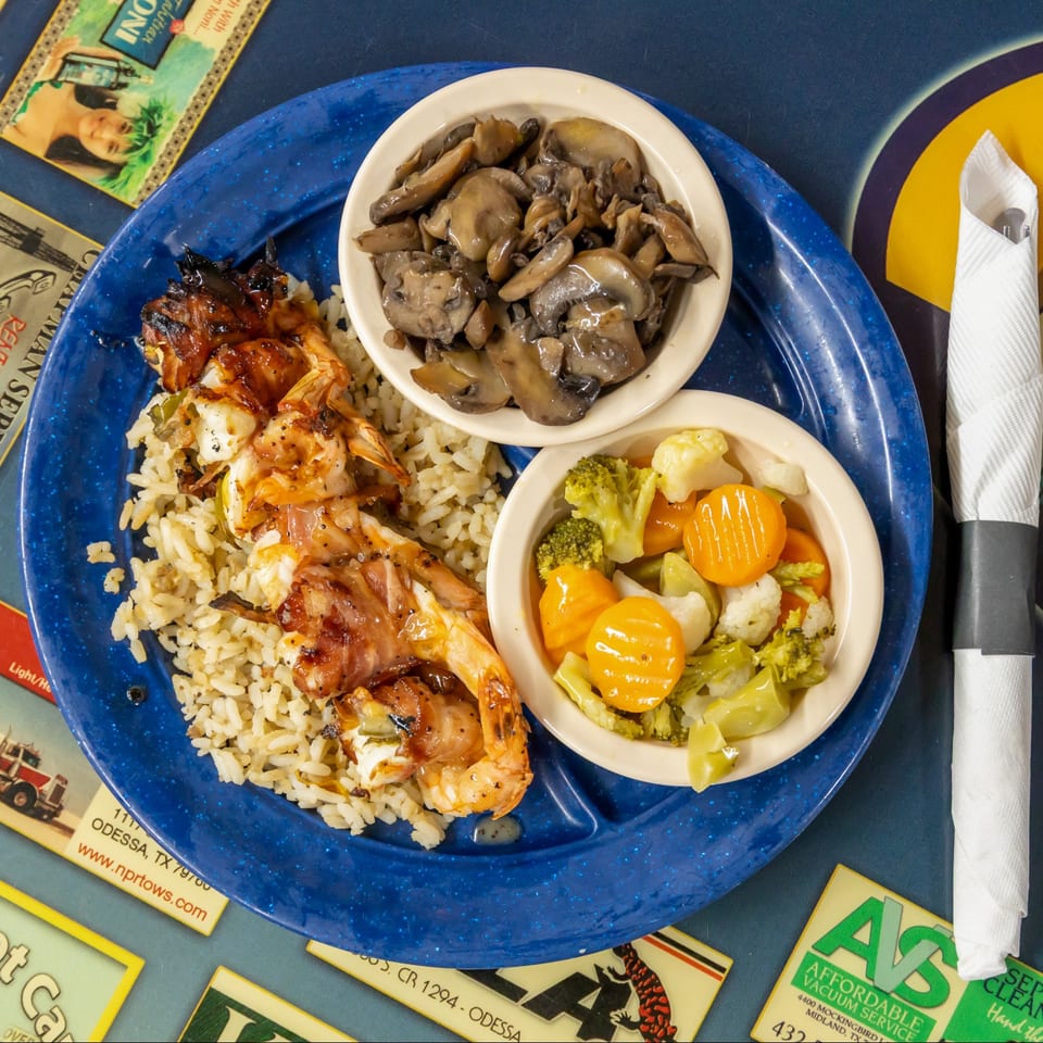 Baja grilled shrimp over rice with mushrooms and vegetables.